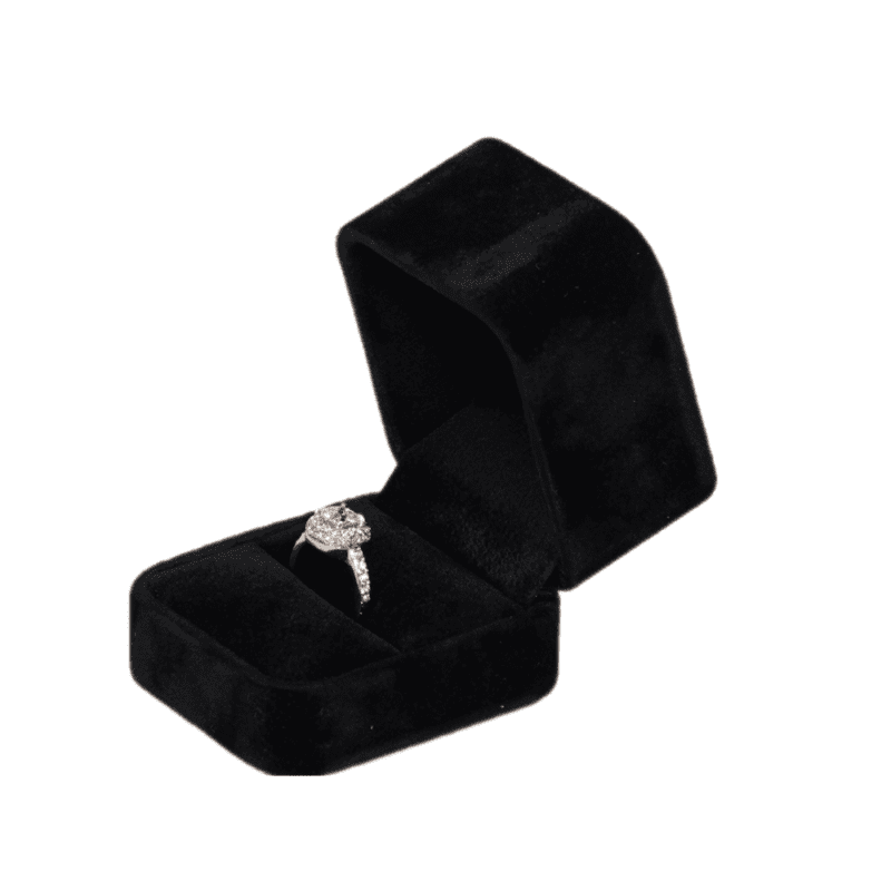 Black velvet ring box with a cushion interior, displaying an engagement ring